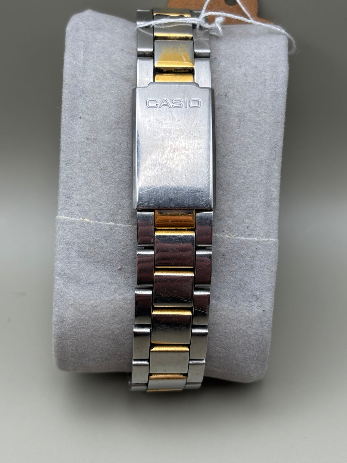 Casio two tone bracelet and signed clasp showing wear